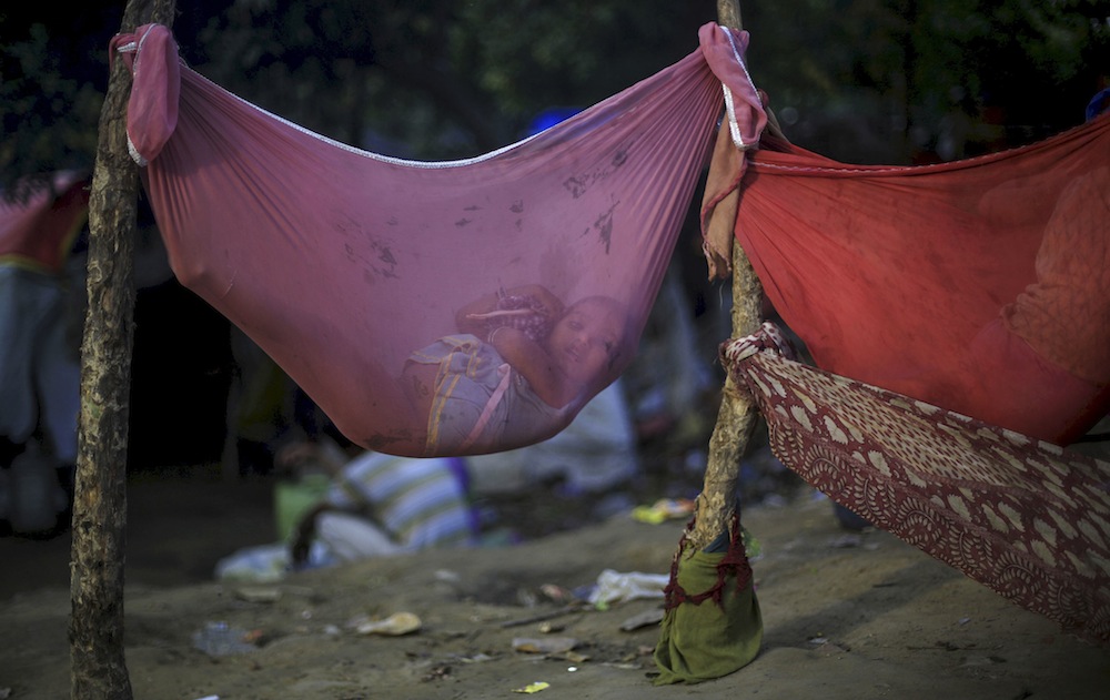 Girl in hammock, New Delhi slum